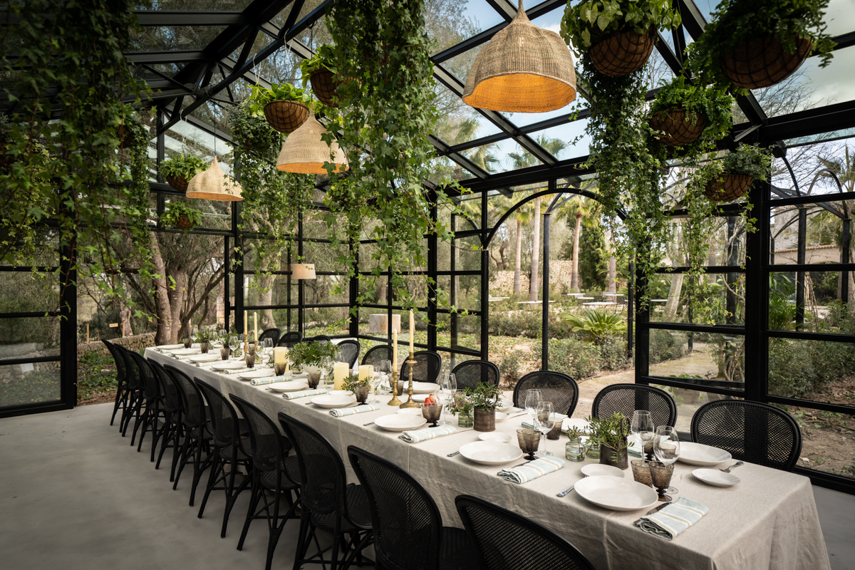 Long table set under a greenhouse roof — Experiences
